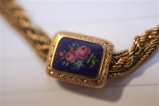 An early 20th century gold triple strand Albertina ropetwist chain, with floral enamelled plaques, gross 38.8 grams.